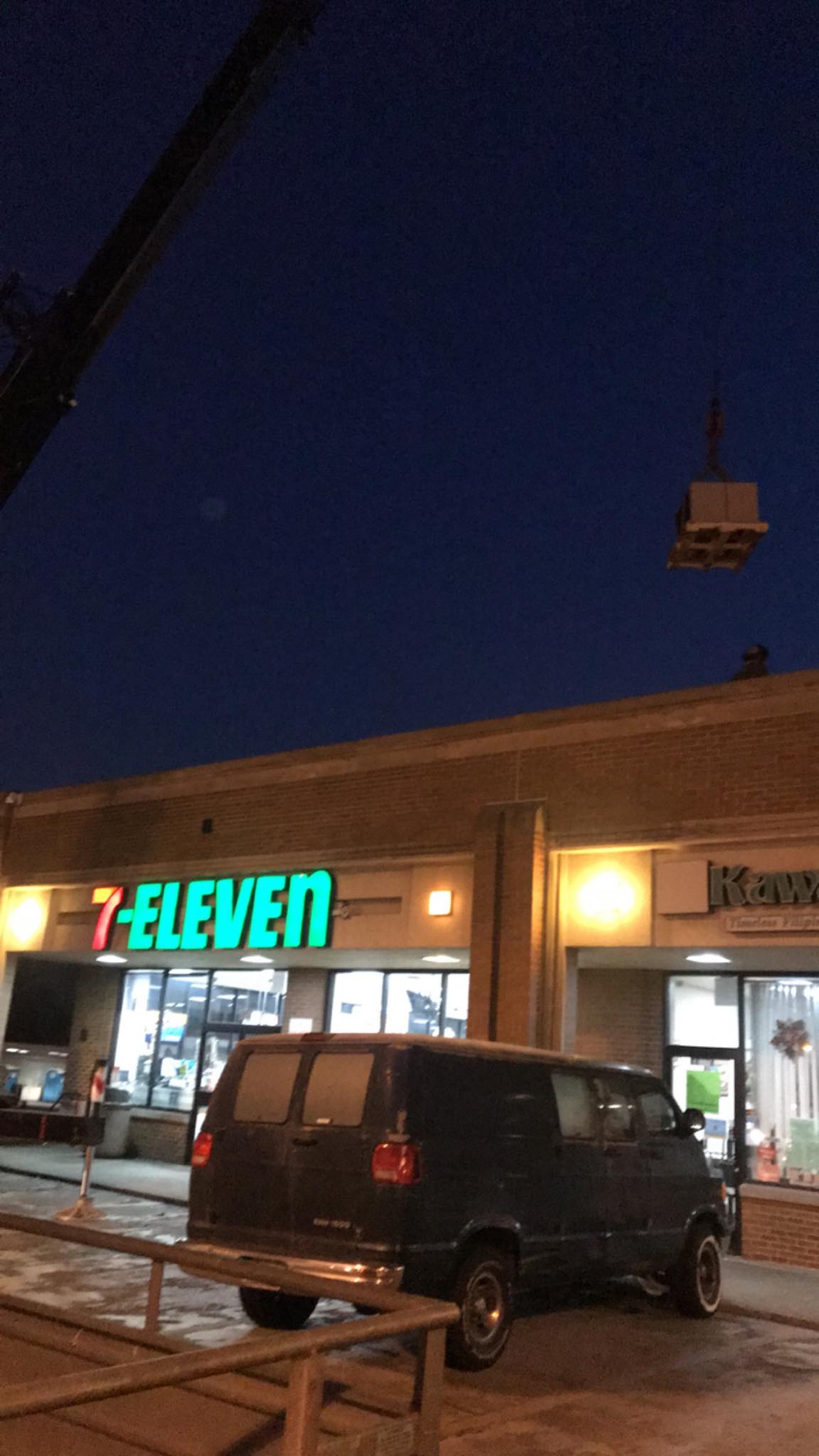 A van is parked in front of a 7 eleven store
