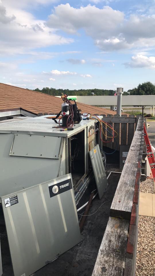 A man is working on the roof of a building.