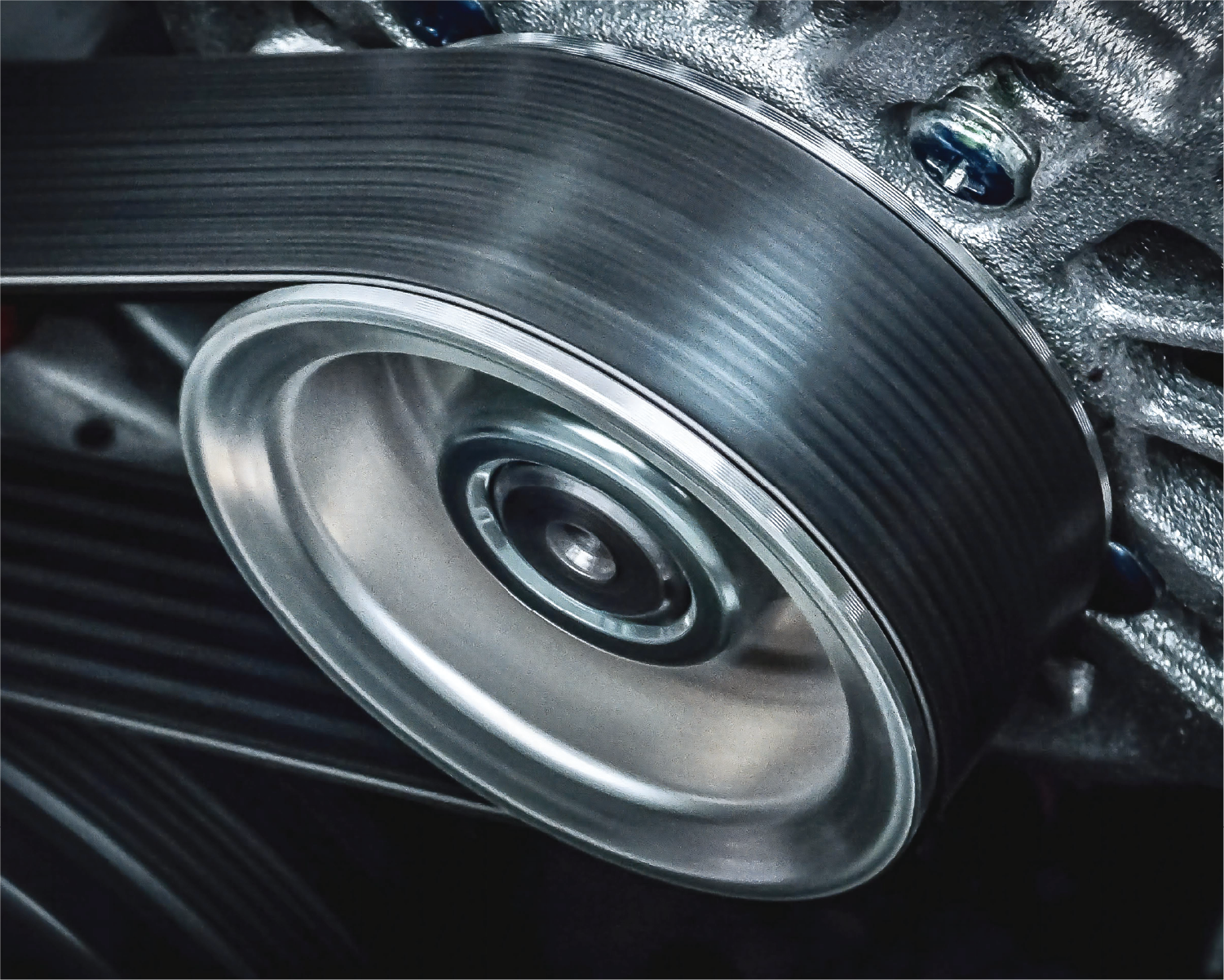 A man is holding a clutch disc in his hands.