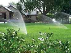 automatic sprinkler system watering front lawn