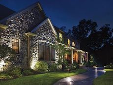 house lit up by landscape lighting at night