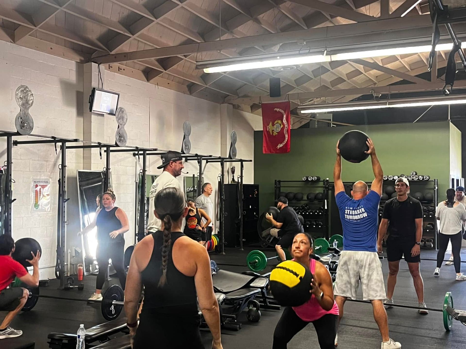 A group of people are doing exercises in a gym.