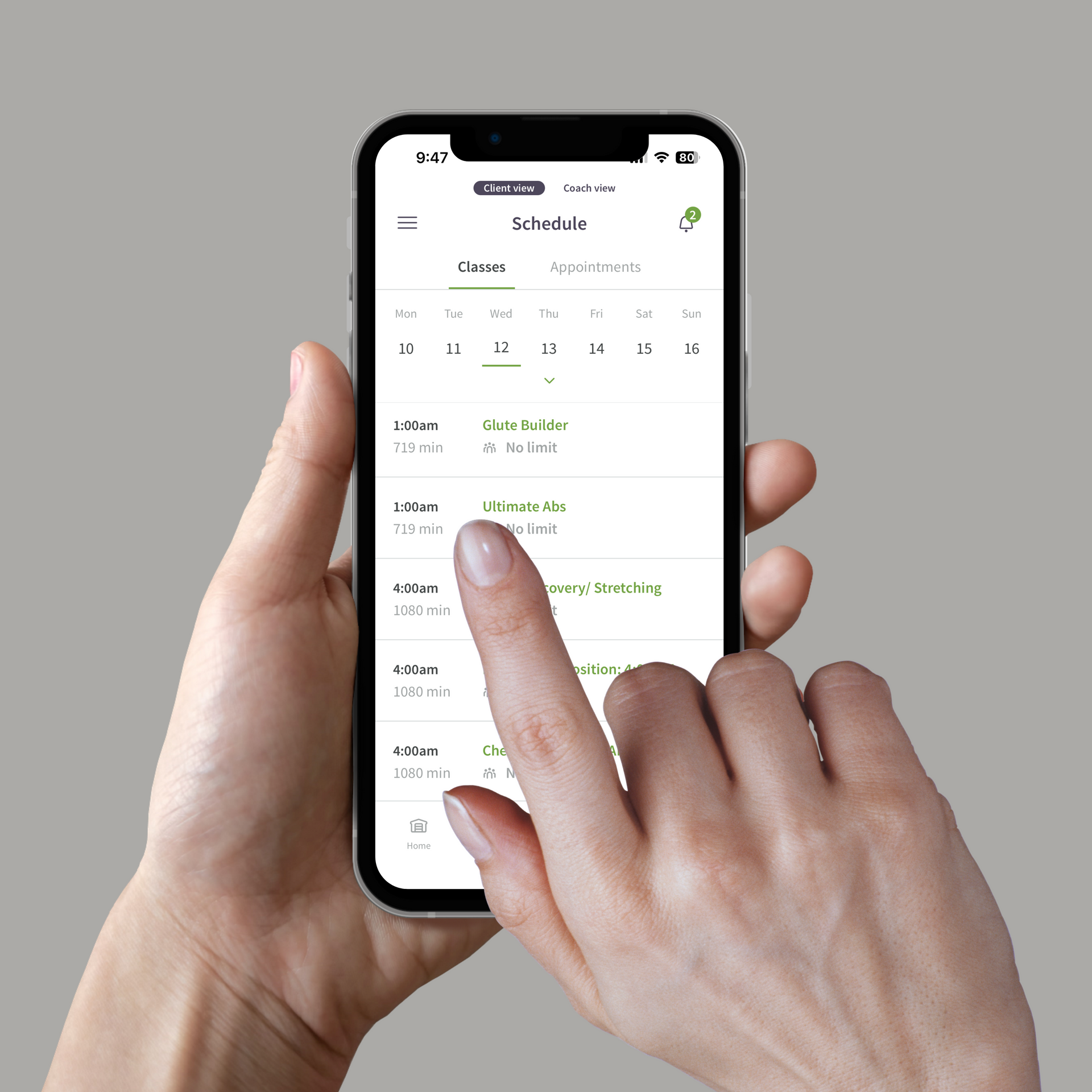 A person is holding a cell phone with their finger on the screen.