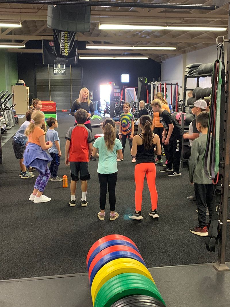 A group of children are standing in a gym.