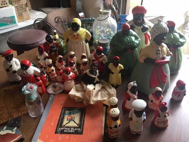 Collection of Black Americana figurines, mostly ceramic, on a table.