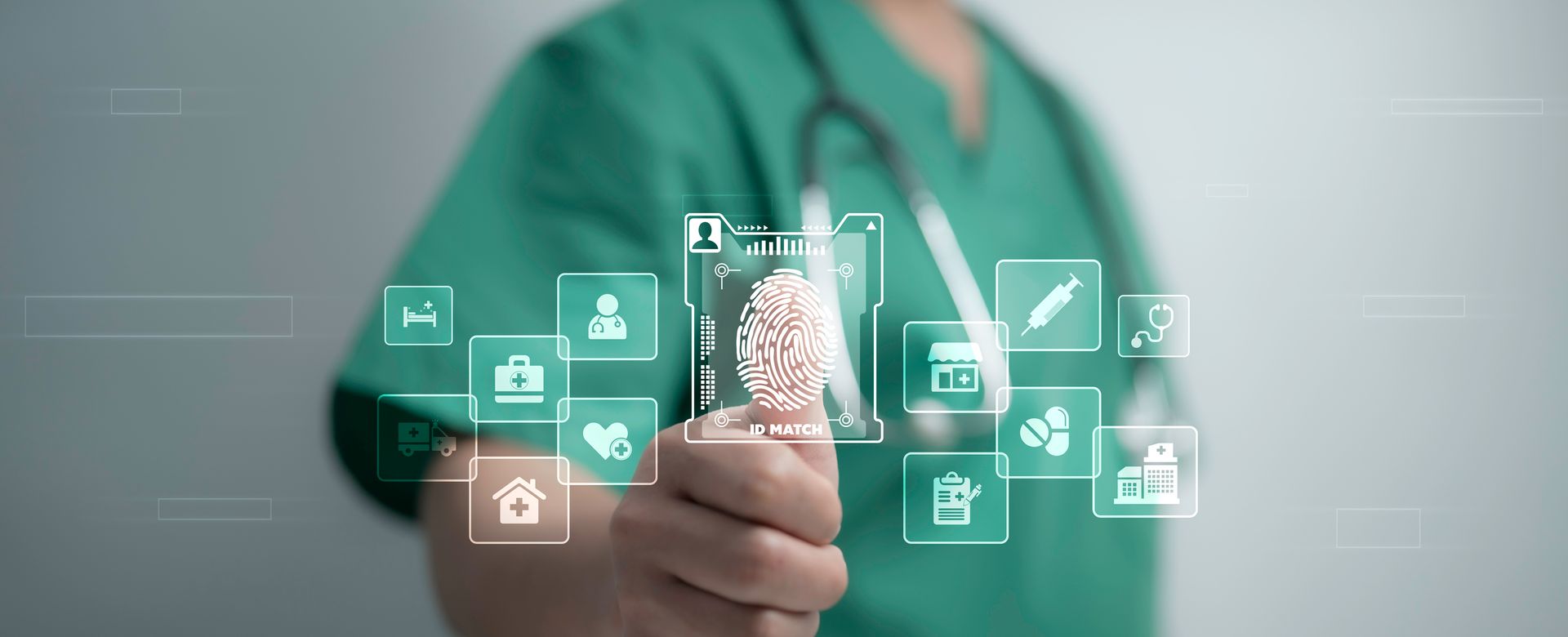 A doctor is holding a pen in front of a screen with icons on it.