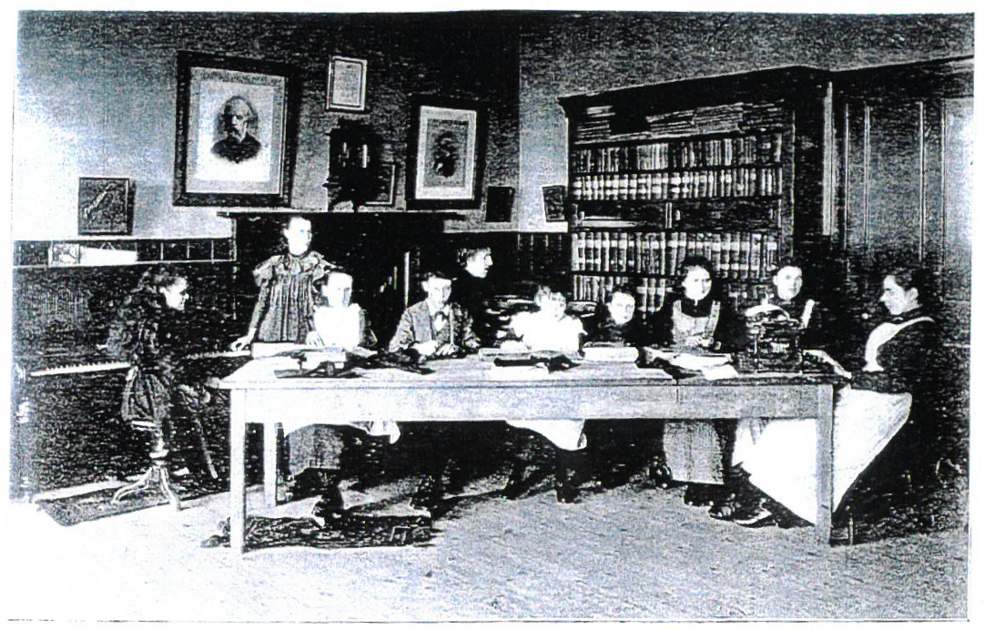 A group of people are sitting around a table in a room.