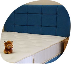 A stuffed animal is sitting on top of a mattress