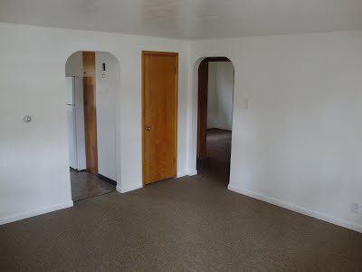 the doorways from the living room to the hallway and kitchen