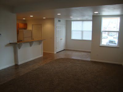 The living room, entryway, and kitchen