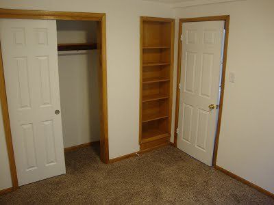 A bedroom with closet and storage space