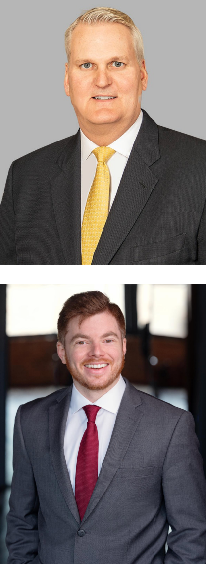 Two men in suits and ties are posing for a picture.