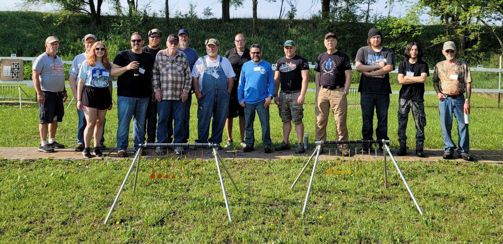 groupe of several men standing in line for photo at gun range