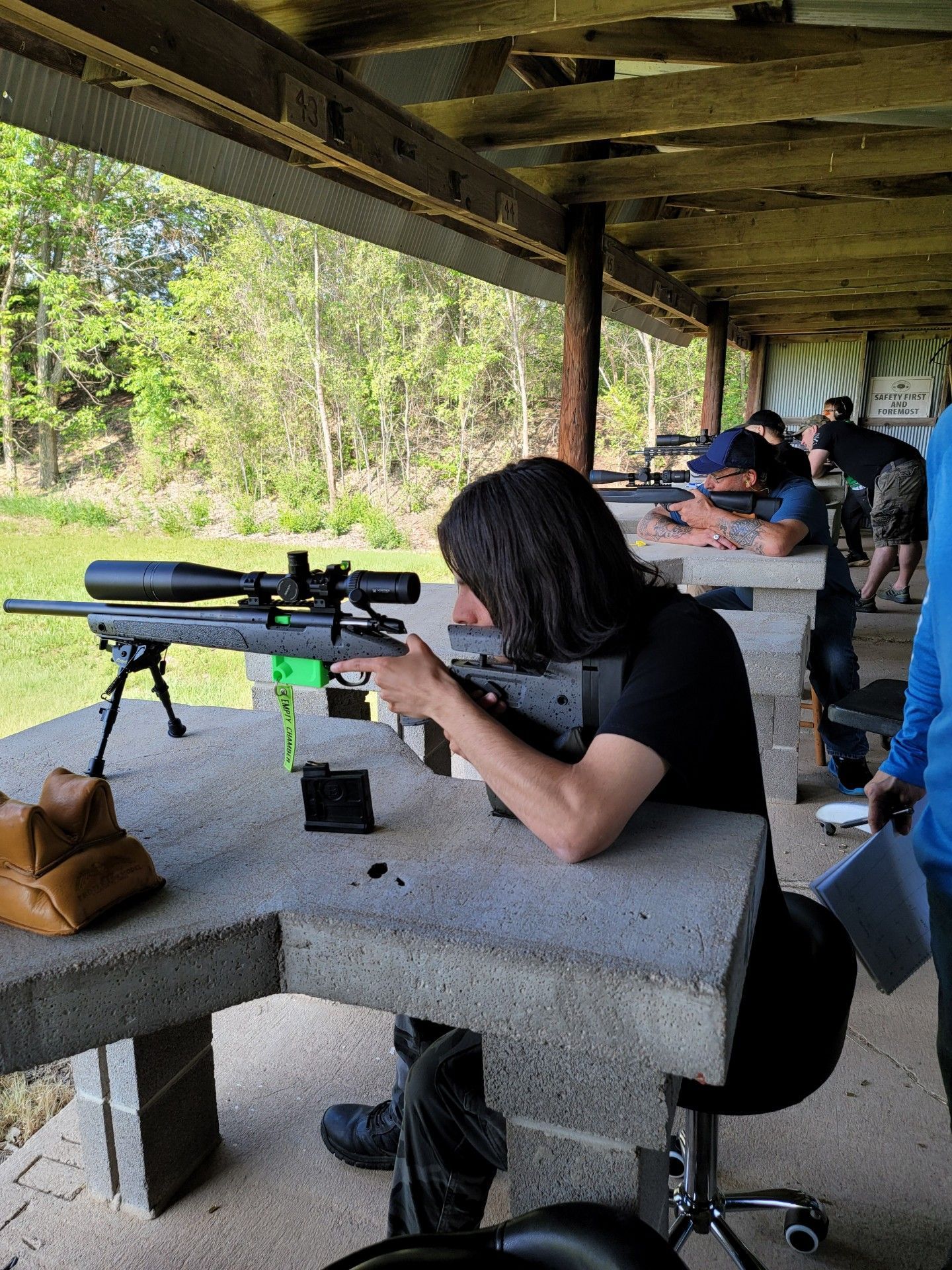 young man aiming rifle at gun range