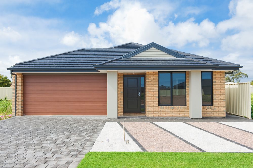 Single-story House With Brown Garage Door, Brick Facade, and Gray Driveway — Ironbark Built Townsville in Kirwan, QLD