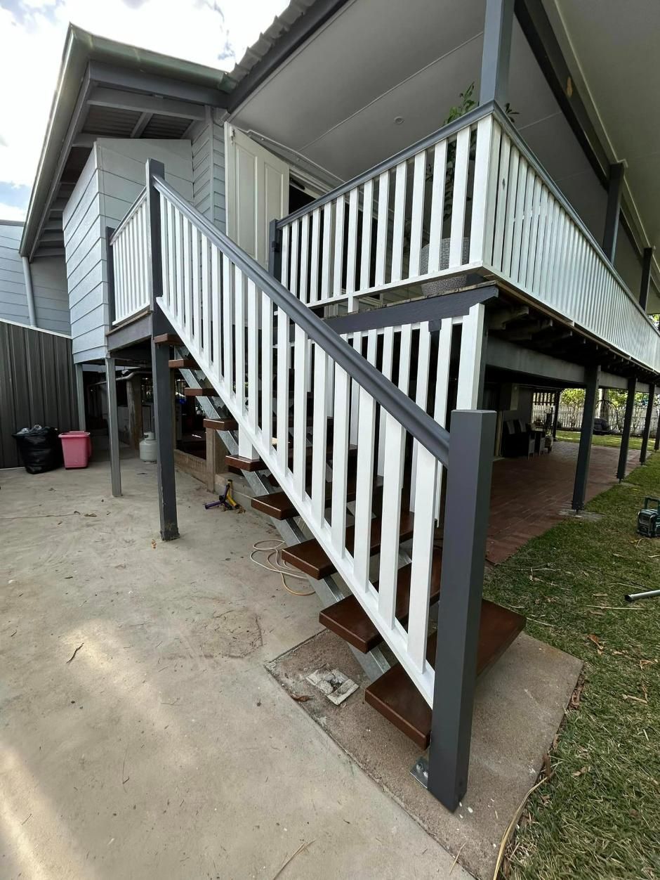 Woman is Walking Up a Set of Wooden Stairs — Ironbark Built Townsville in Mundingburra, QLD