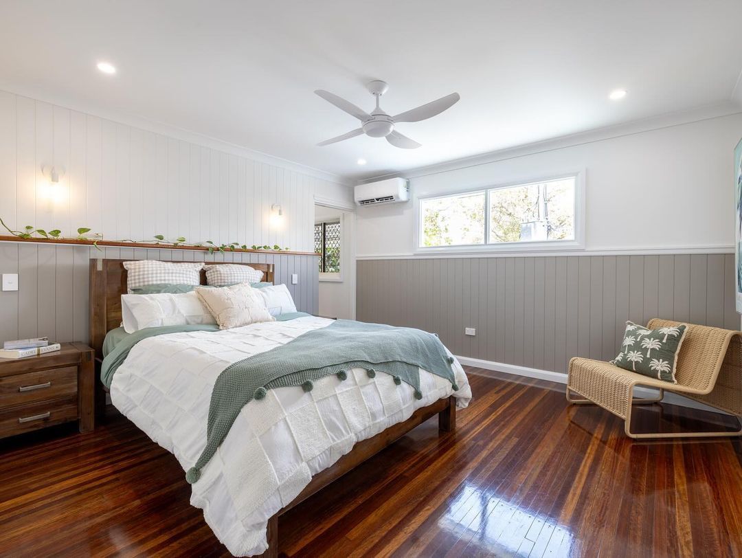 Bedroom with A Bed, Chair, Nightstand and Ceiling Fan — Ironbark Built Townsville in Mundingburra, QLD