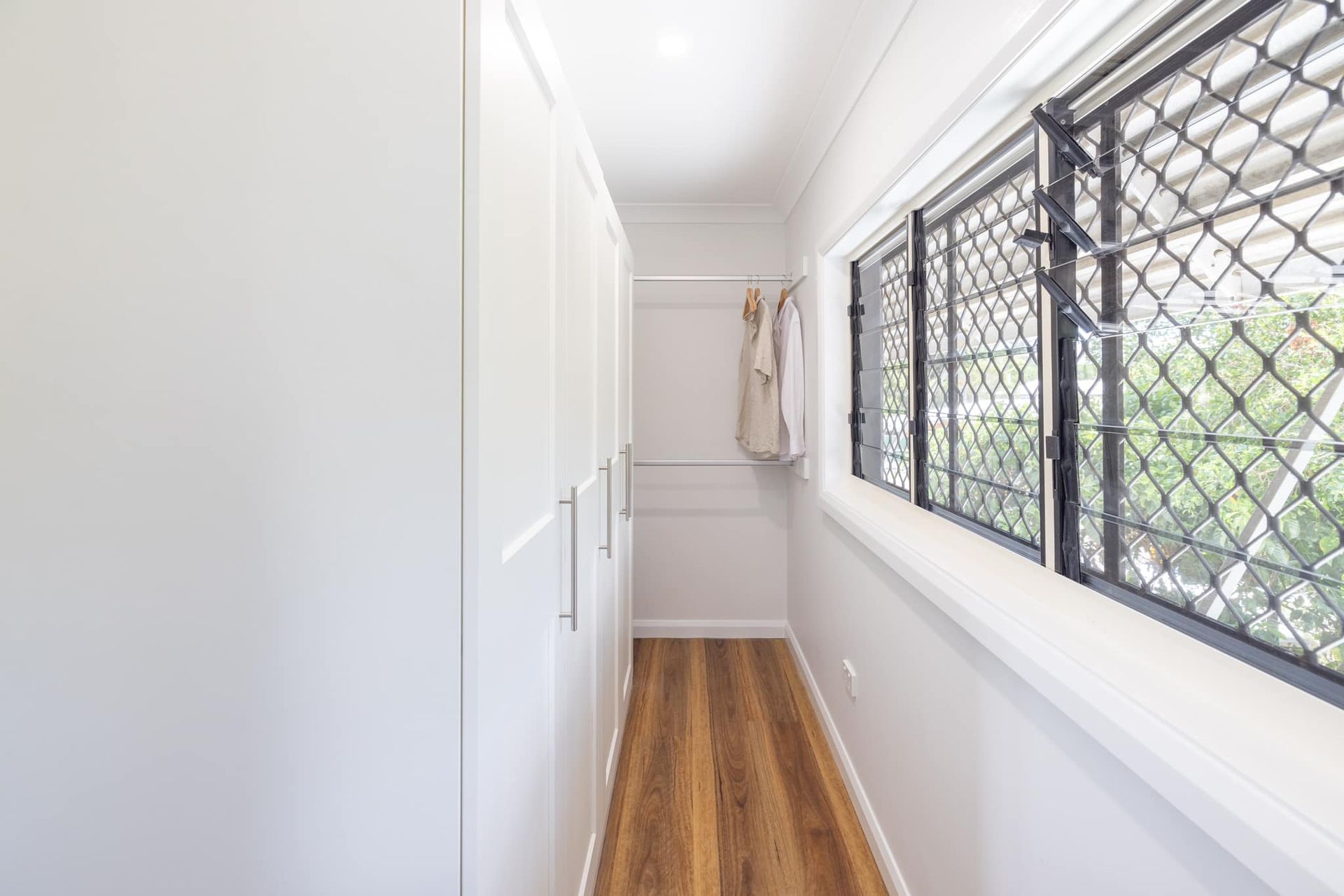 Walk-In Closet With White Cabinets And Windows — Ironbark Built Townsville in Mundingburra, QLD
