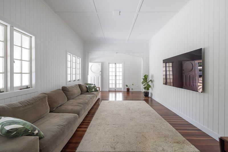 Living Room with A Large Couch and A Flat Screen TV on The Wall — Ironbark Built Townsville in Mundingburra, QLD