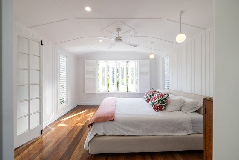 White Bedroom With Wooden Floors And Pendant Lights — Ironbark Built Townsville in Mundingburra, QLD