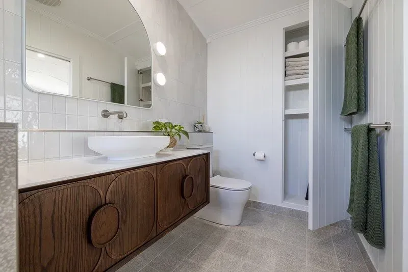 A Bathroom With a Sink, Toilet and Mirror — Ironbark Built Townsville in Mundingburra, QLD