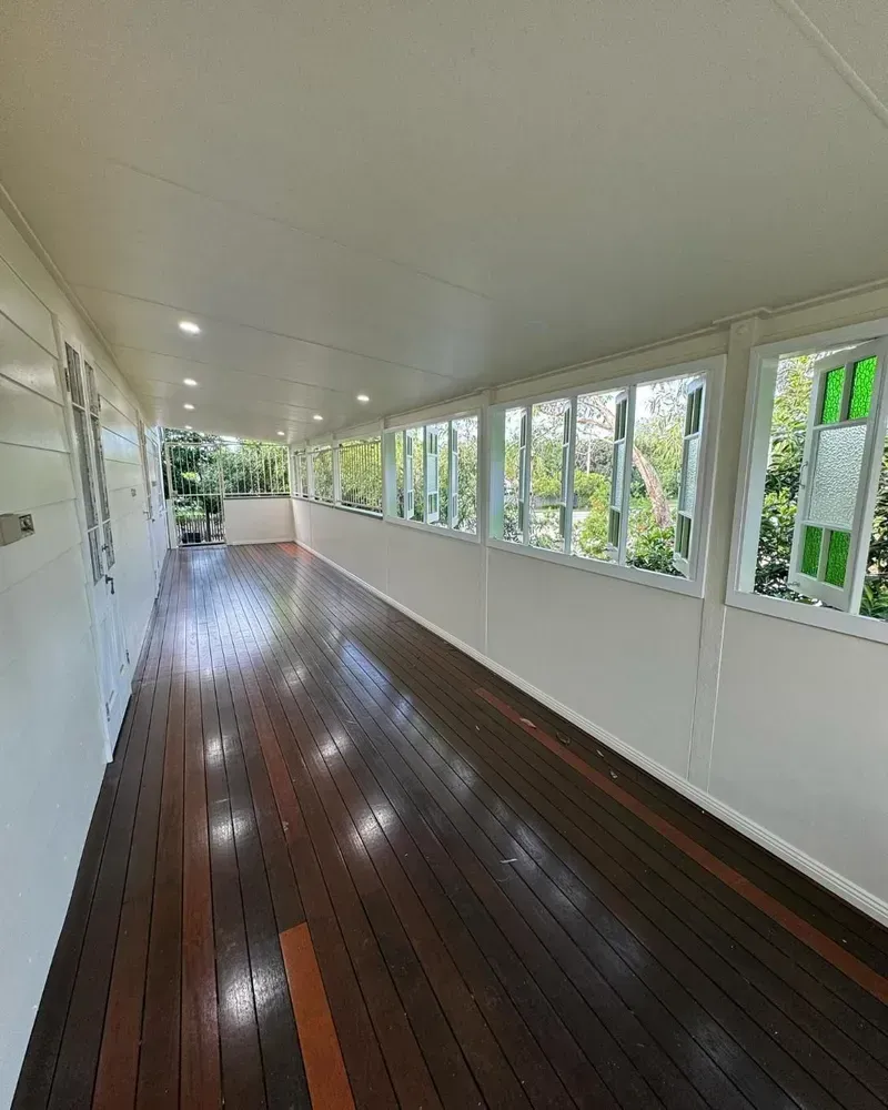 A Long Hallway With Wooden Floors and Lots of Windows — Ironbark Built Townsville in Mundingburra, QLD