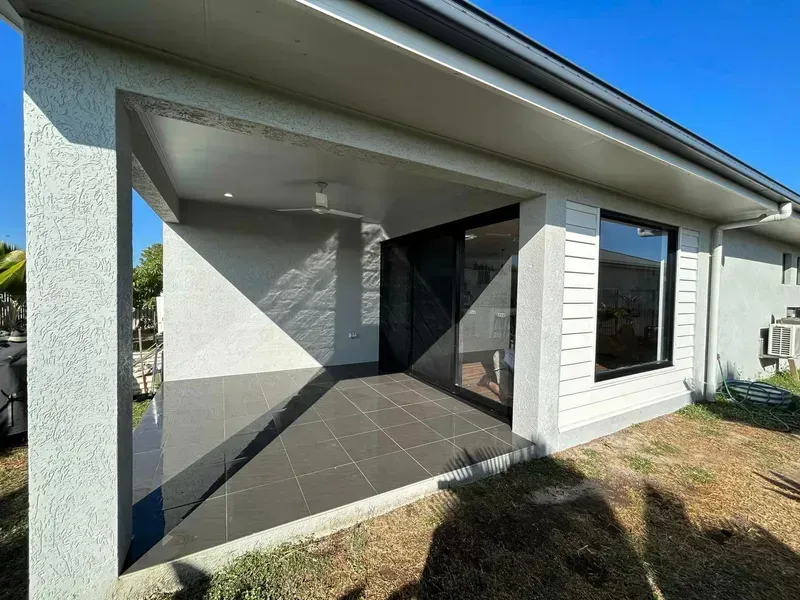 A White House With a Covered Porch and a Sliding Glass Door — Ironbark Built Townsville in Mundingburra, QLD