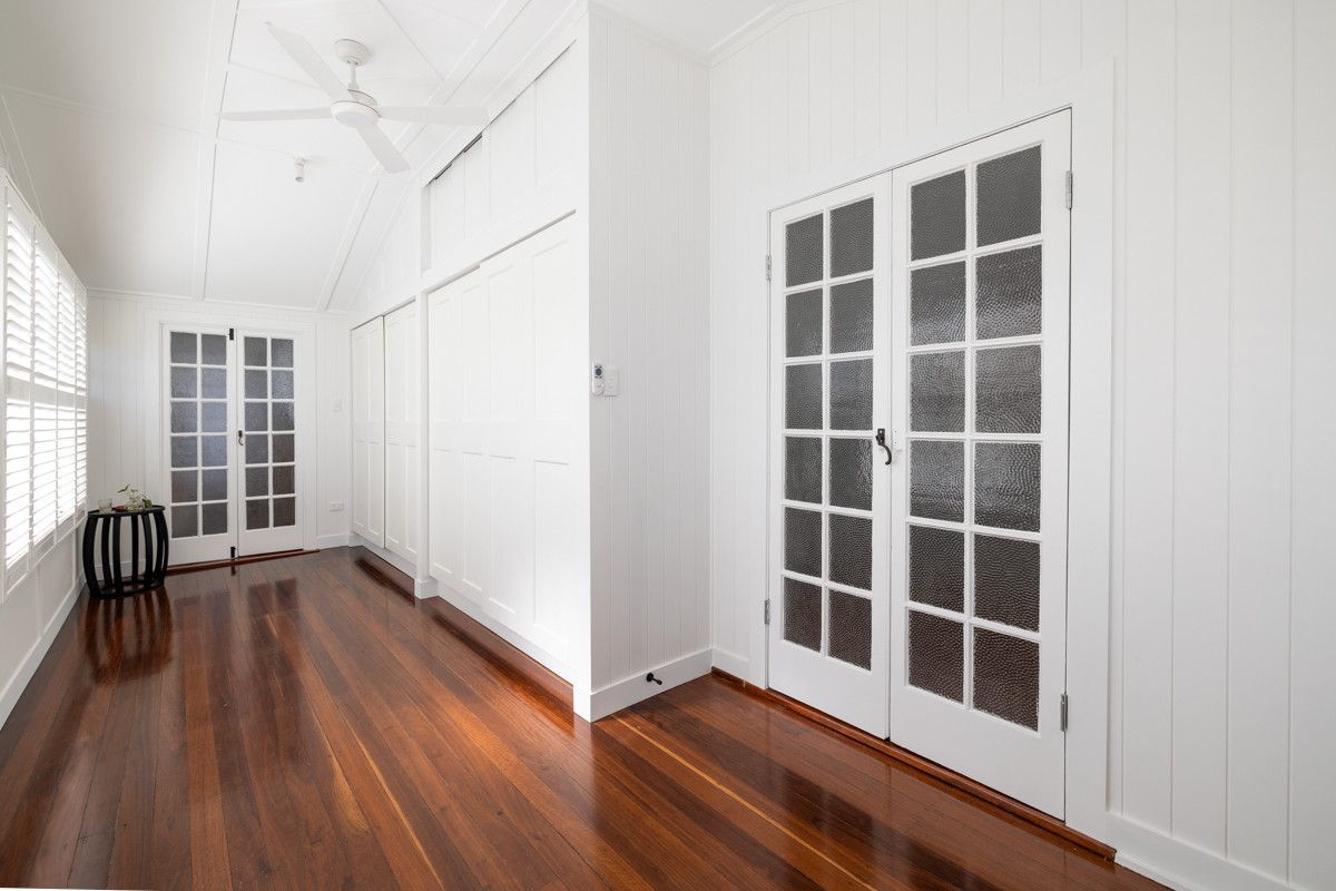 An Empty Room With Hardwood Floors, White Walls And French Doors — Ironbark Built Townsville in Mundingburra, QLD