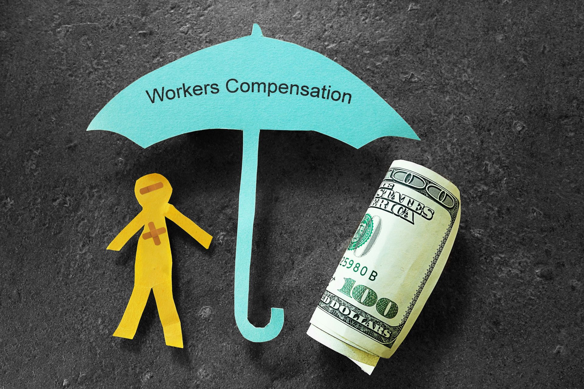 Injured paper man with money, under a workers' compensation umbrella.