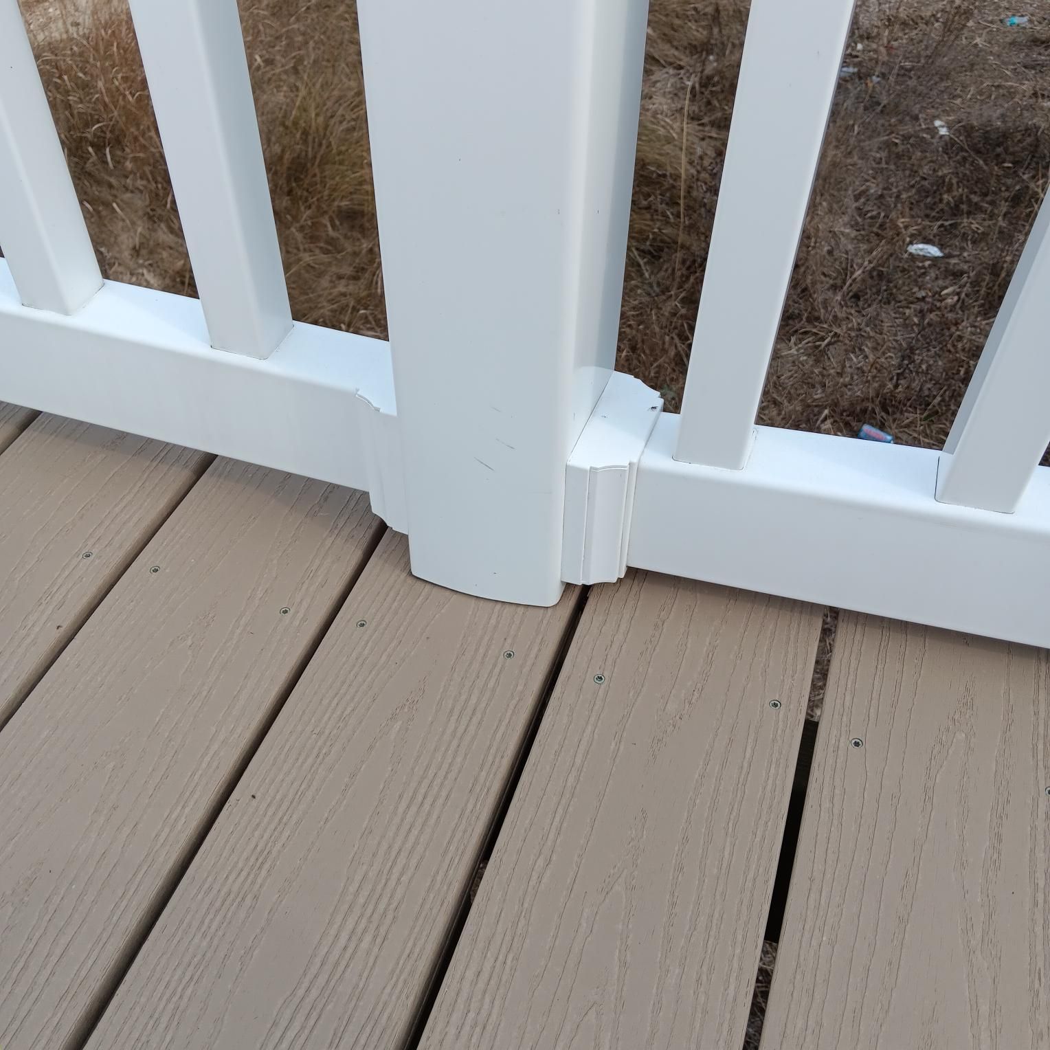 White railing with vertical pickets on a composite deck.