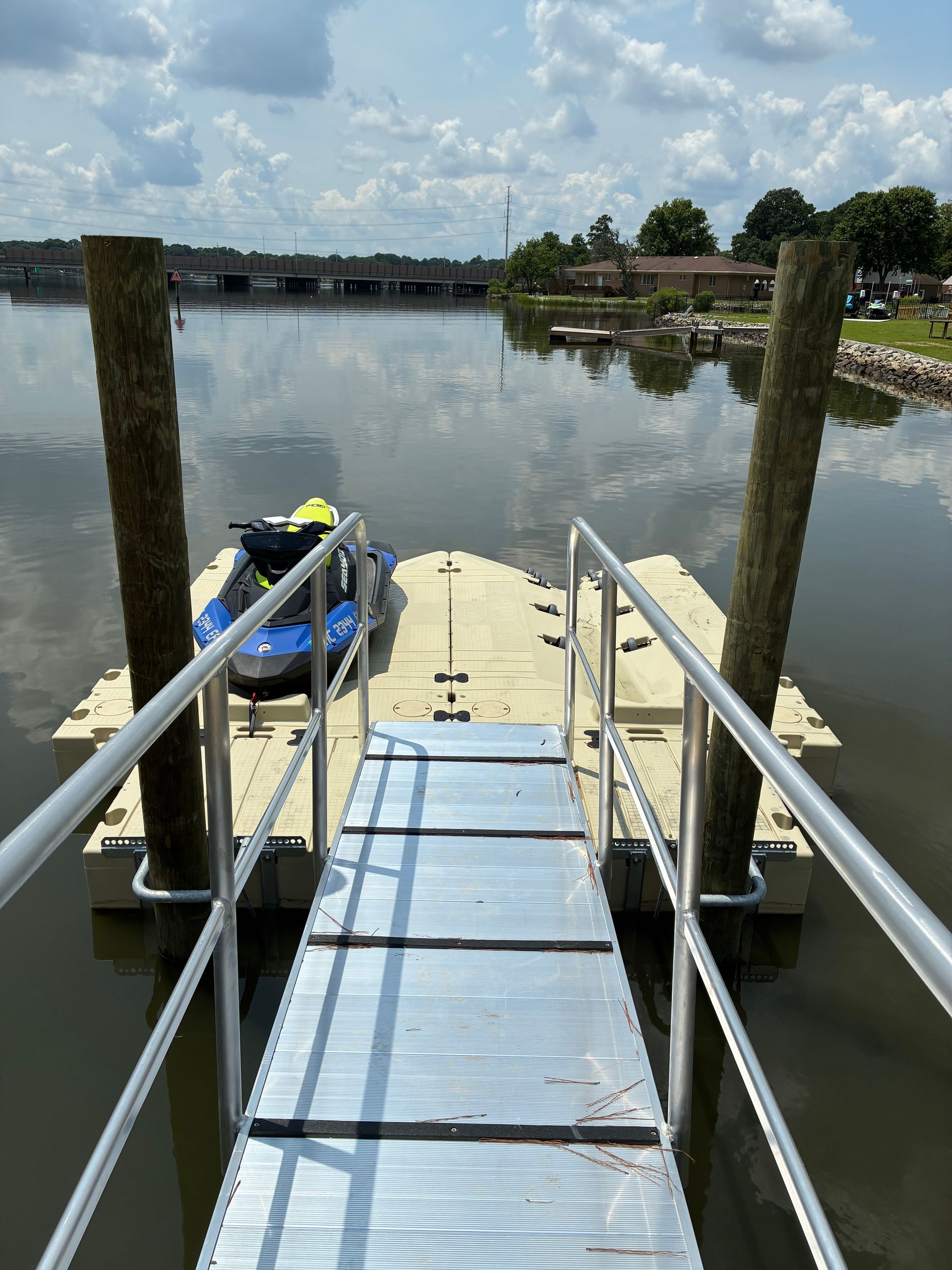 Wooden boats docked on a calm lake under a cloudy sky.