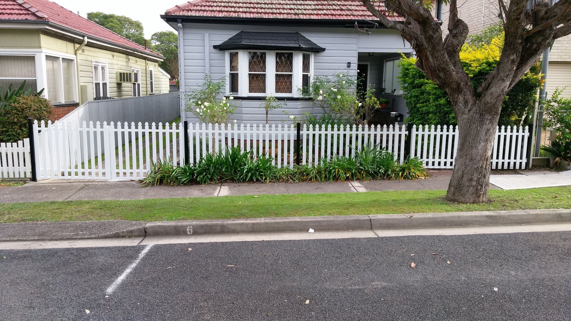 A house with a white picket fence around it