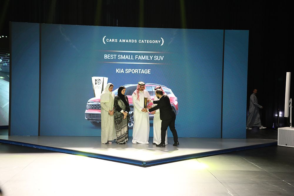 People on stage accepting award for 