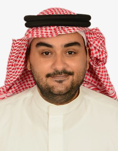 Man wearing traditional Saudi attire, smiling, looking at camera.