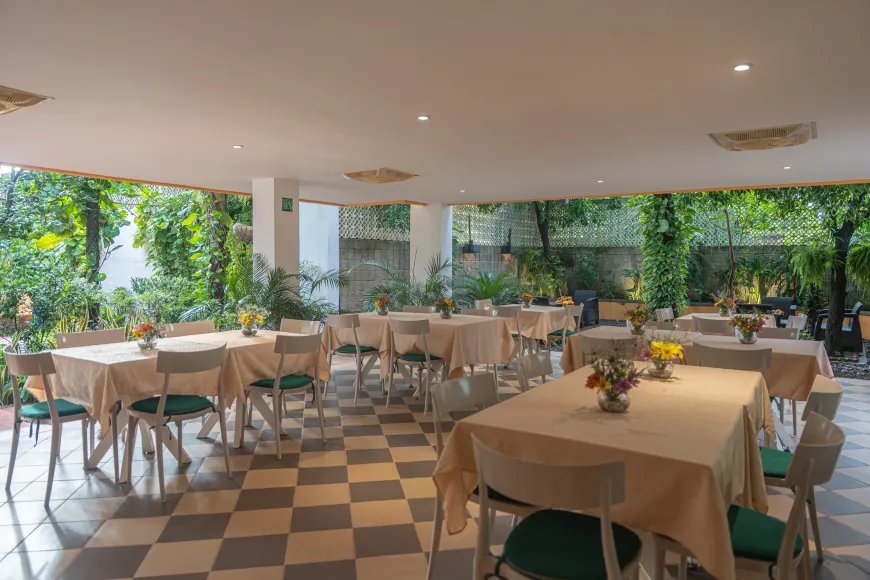 Un restaurante con mesas y sillas y suelo de cuadros.