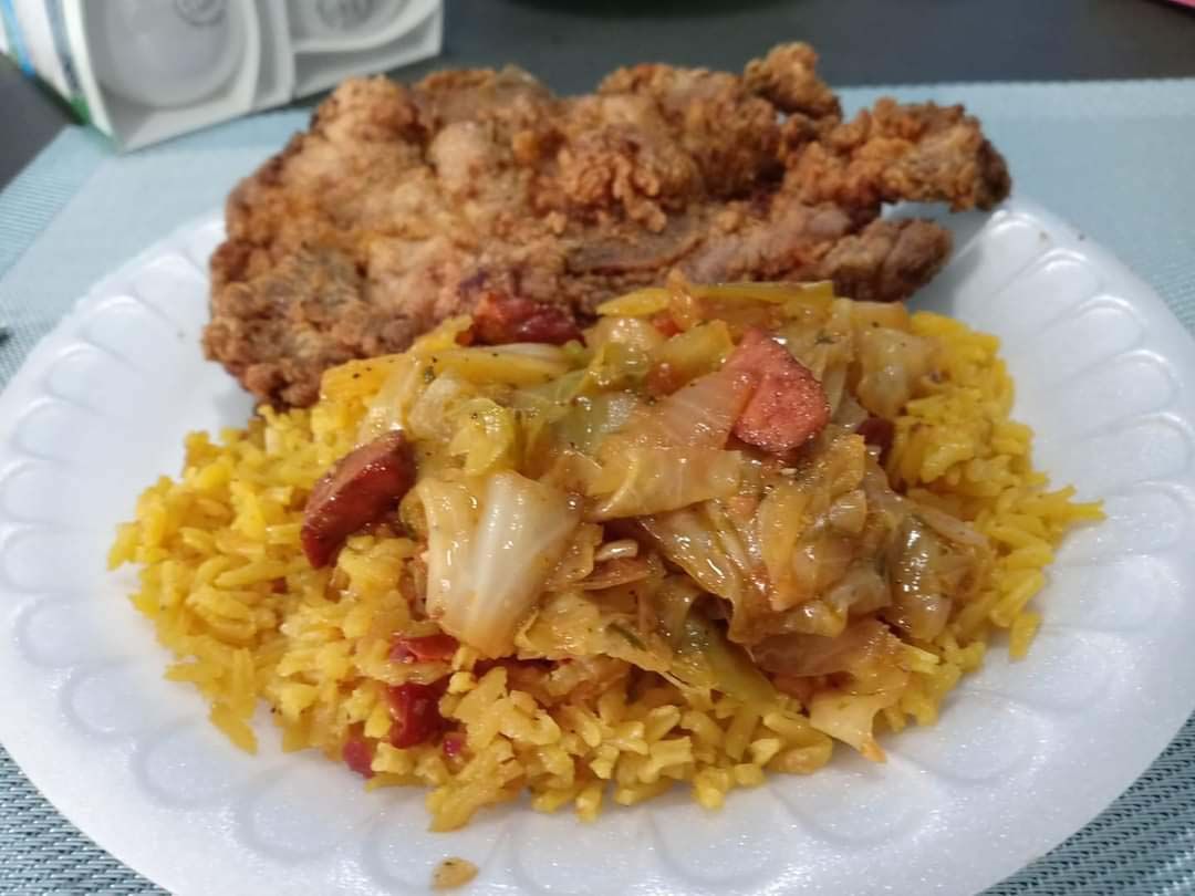 A plate of food with rice and meat on a table