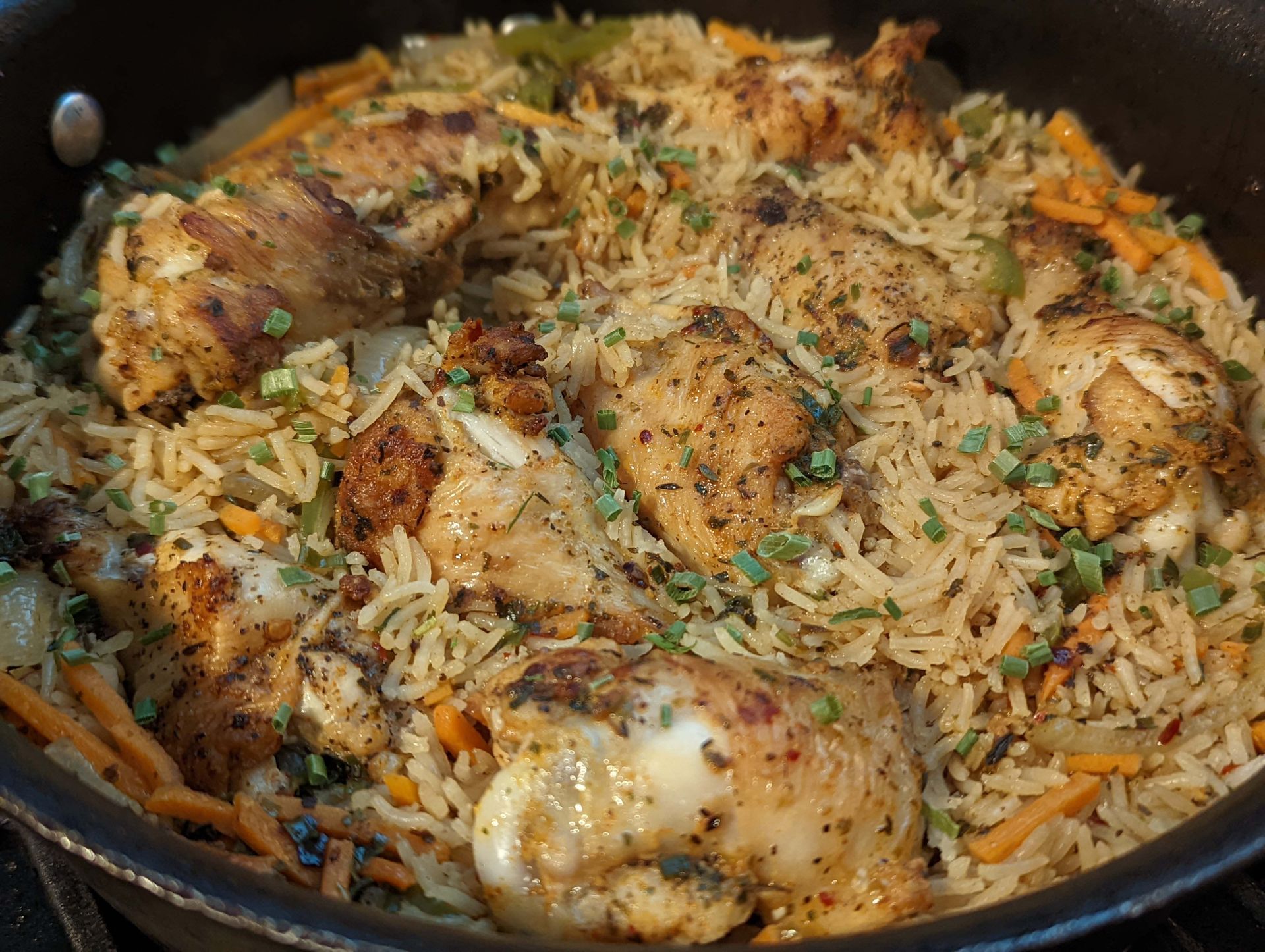 A close up of a pan filled with rice and chicken.