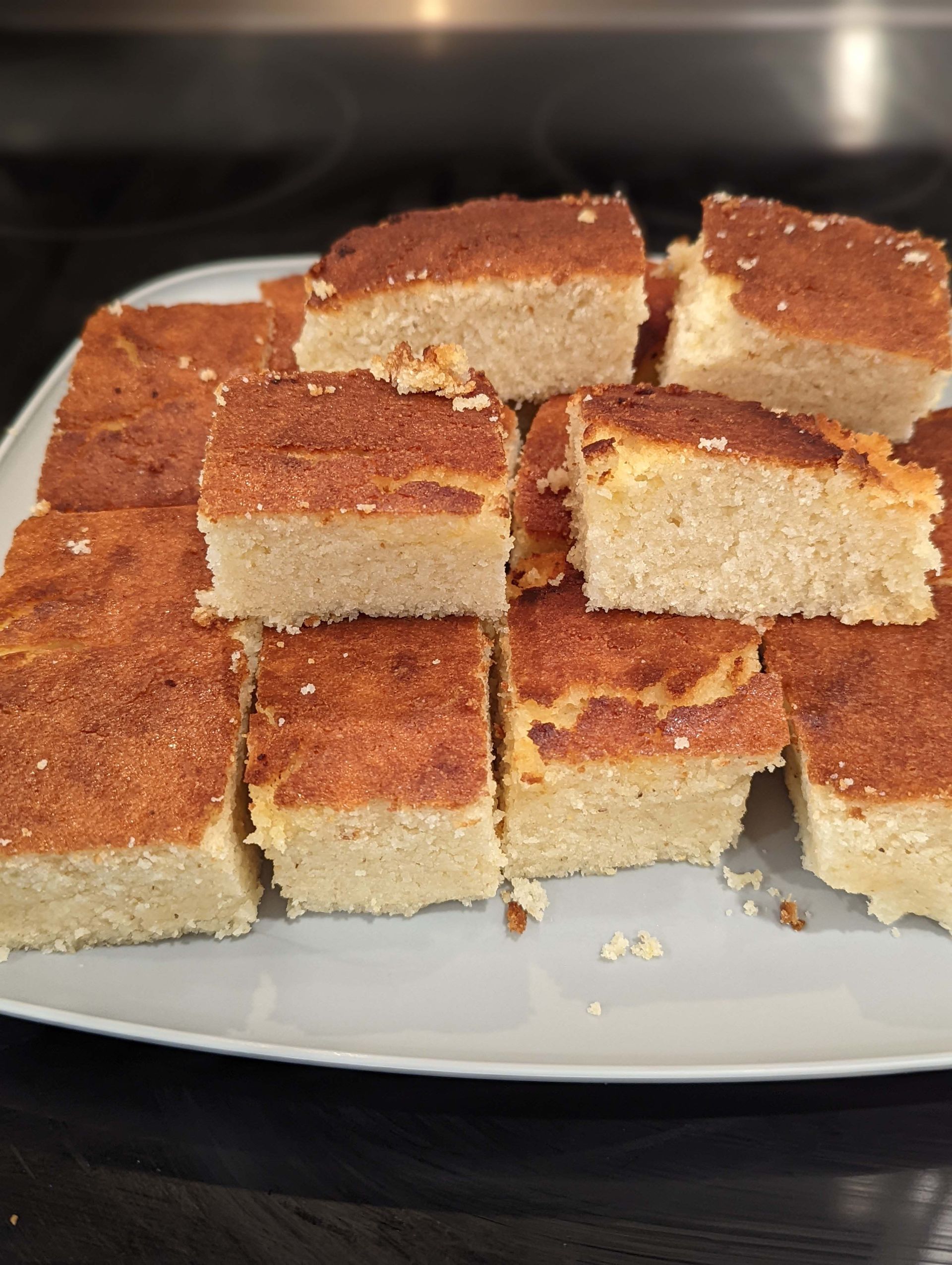 A white plate topped with slices of cake
