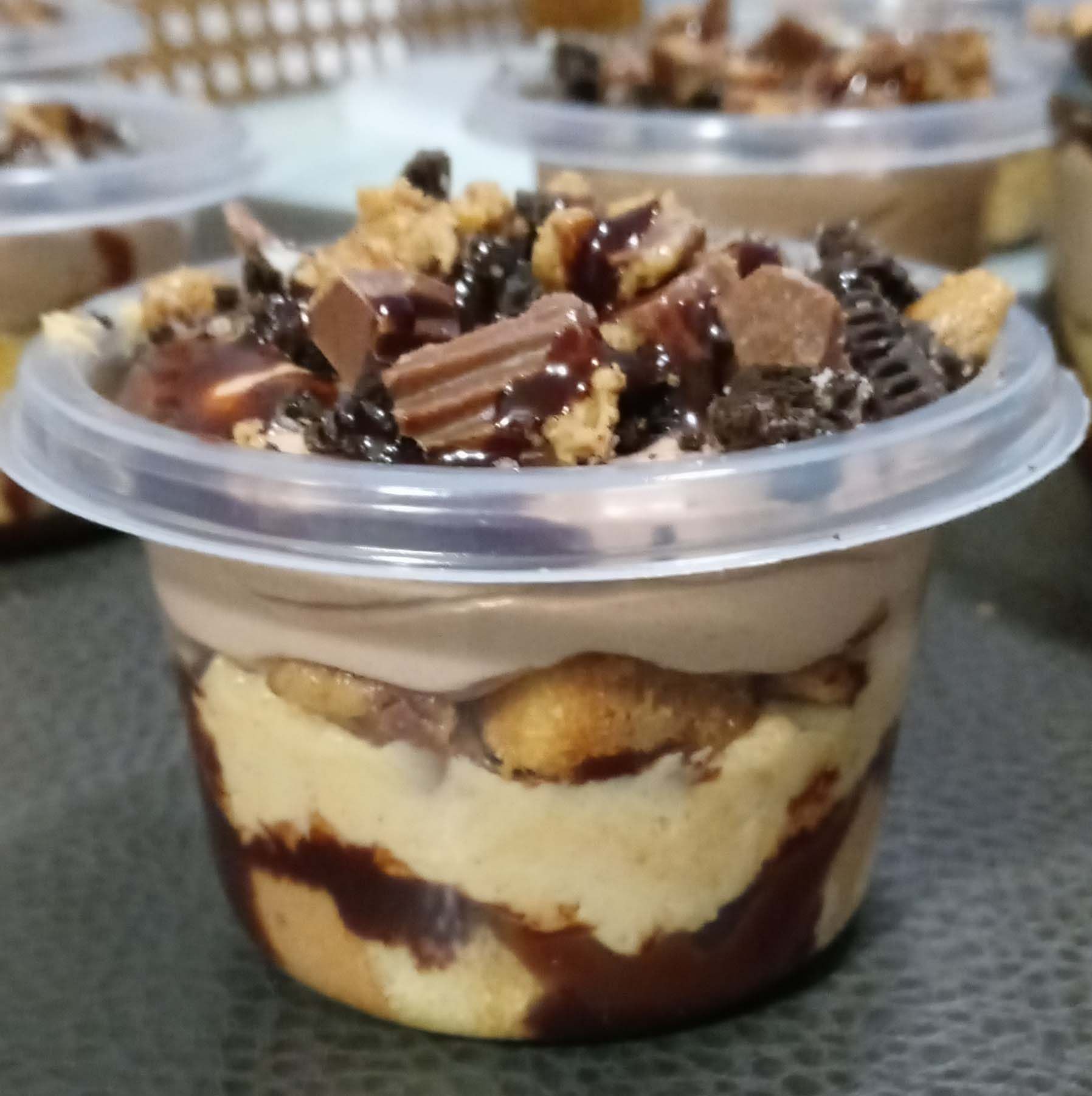 A small plastic cup filled with a chocolate dessert