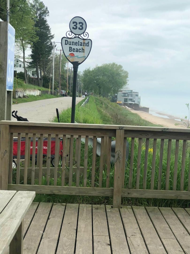 A wooden deck with a sign that says burwald beach