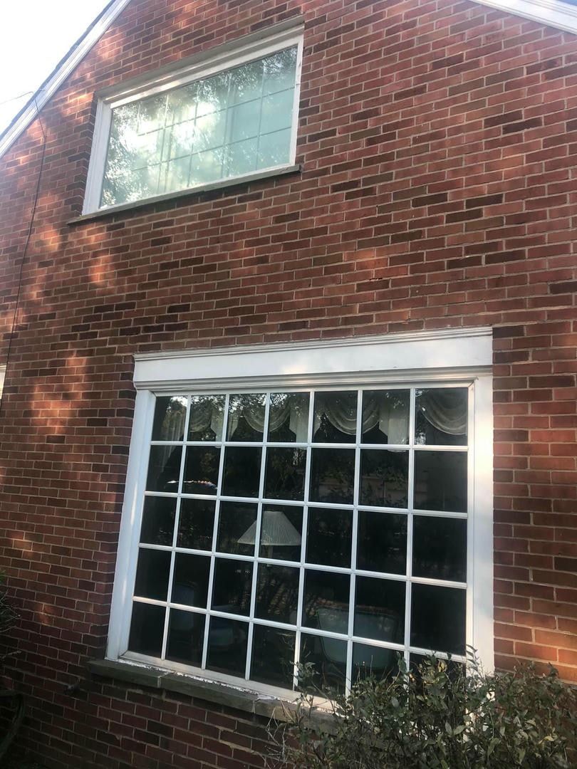 A large window on the side of a brick building.