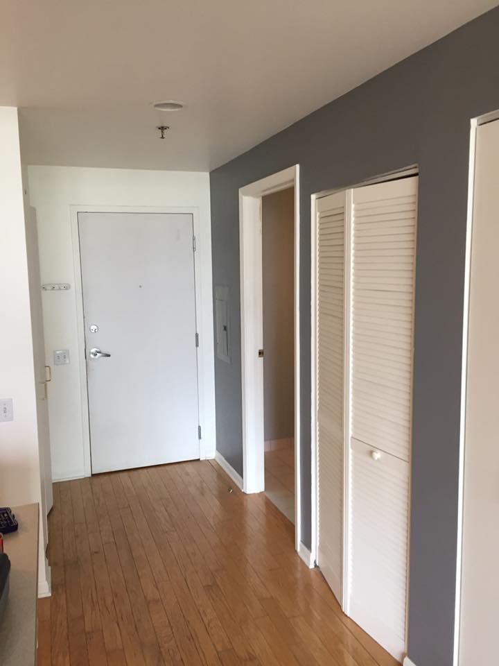 A Hallway With Hardwood Floors And White Doors In A House