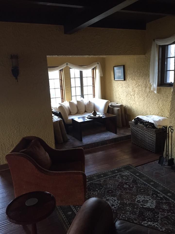 A living room with a couch a chair and a coffee table