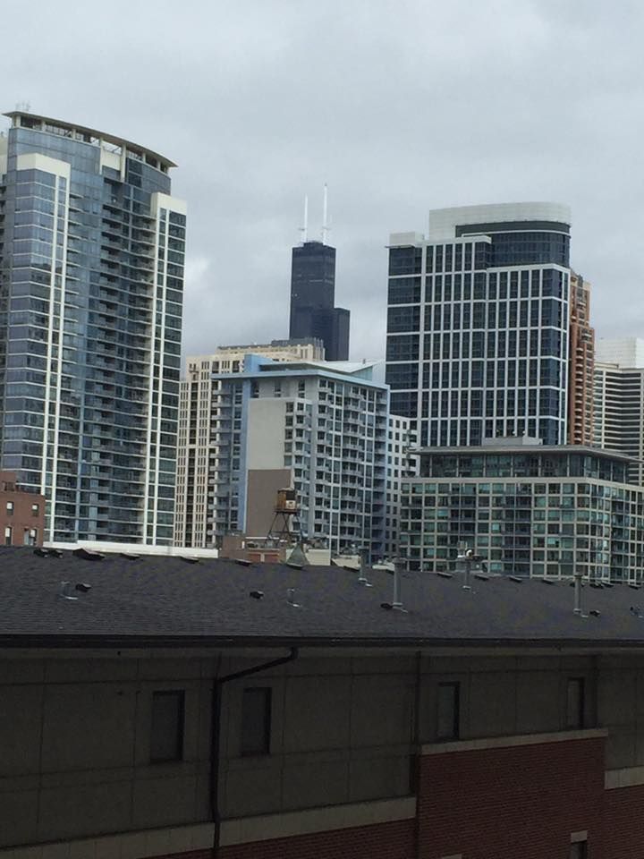 A view of a city skyline from the roof of a building