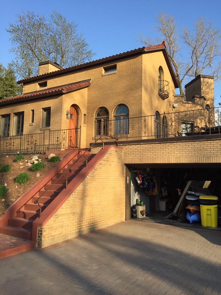 A house with a garage and stairs leading up to it