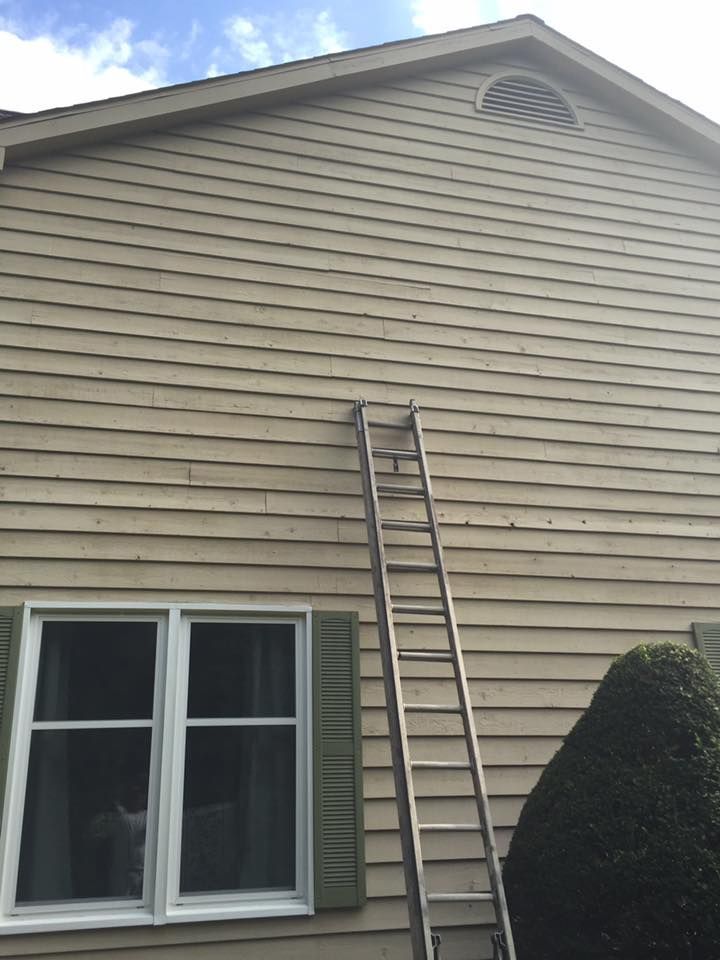 A Ladder Is Leaning Against The Side Of A House