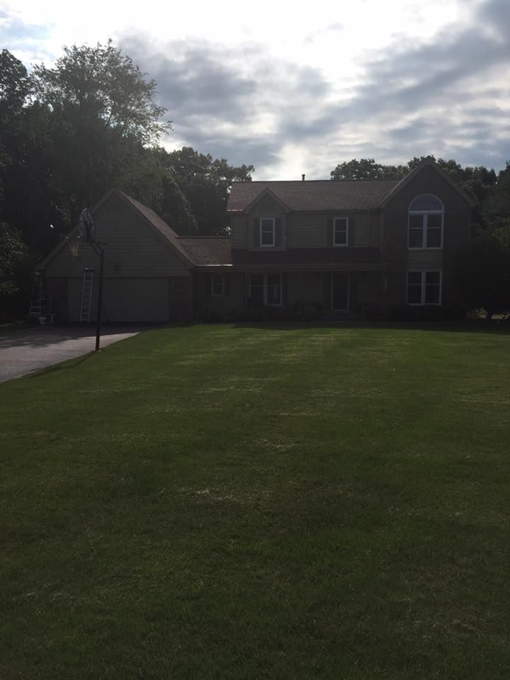 A Large House With A Large Lawn In Front Of It