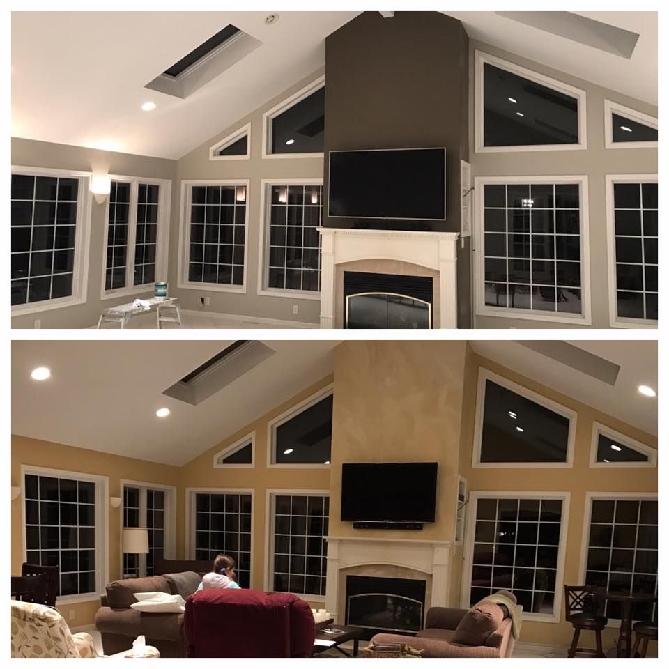 A living room with a fireplace and a flat screen tv