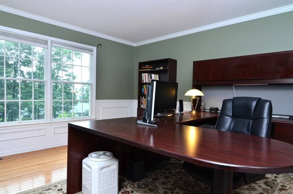 A Home Office With A Large Desk And Chair