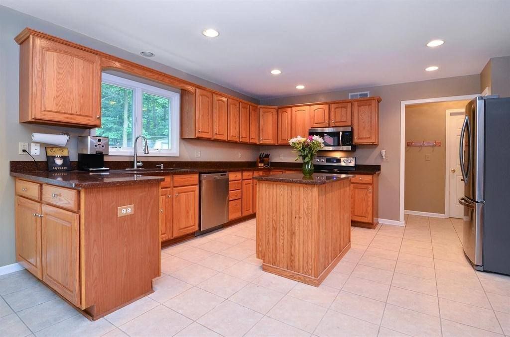 A kitchen with wooden cabinets and stainless steel appliances